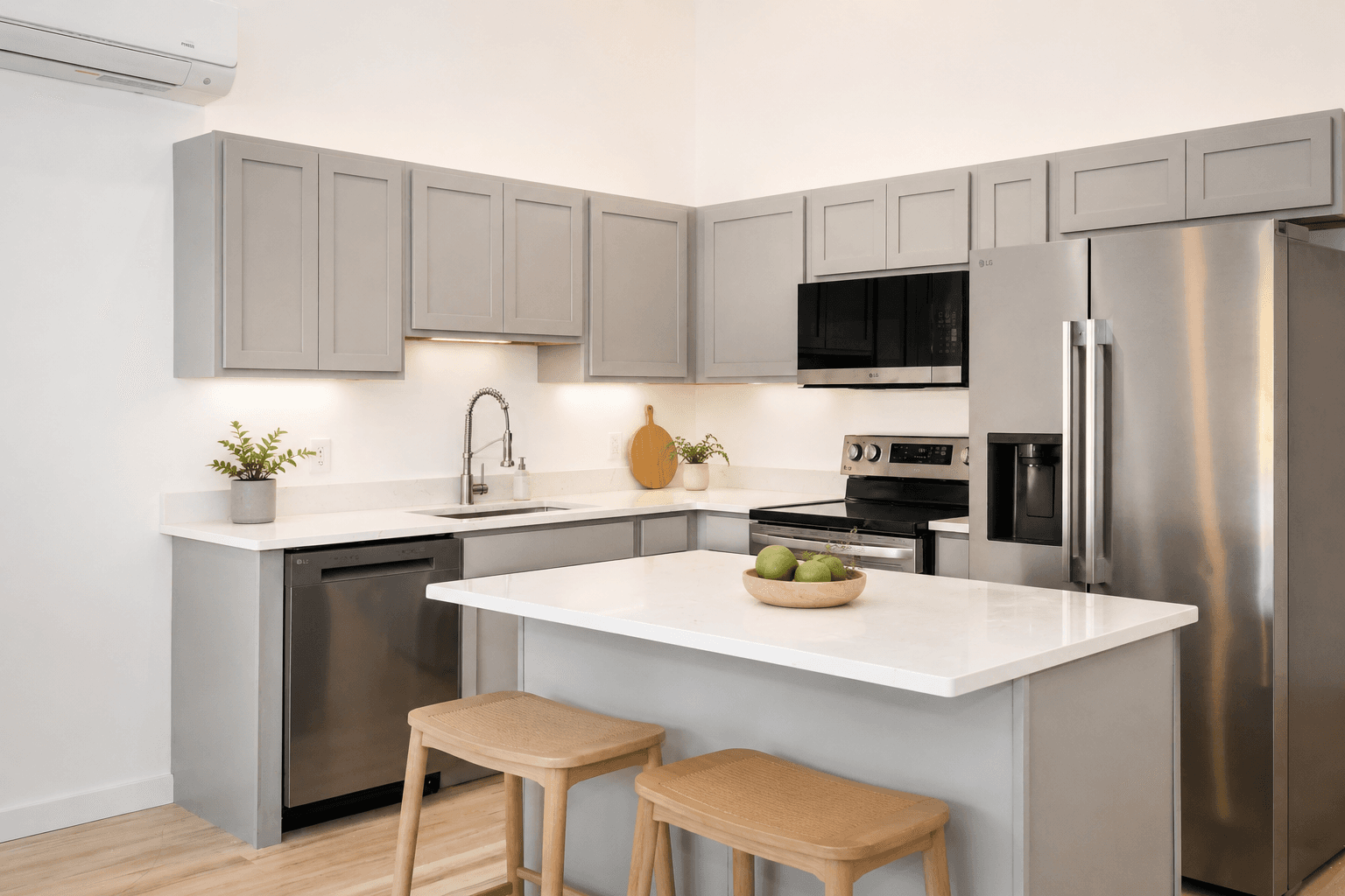 Tillson Woods kitchen with wood cabinetry, quartz counters, stainless-steel appliances, and virtually staged seating.